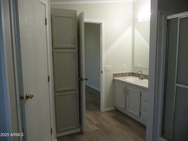 a bedroom with a bed and a night stand