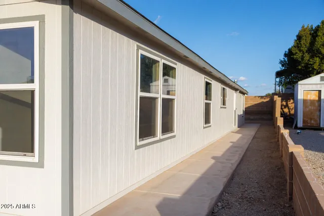 a hallway with wooden floor and windows