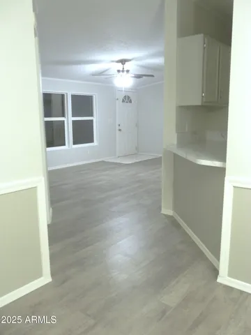 an empty room with windows and fireplace