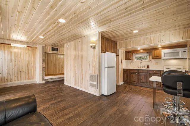 a kitchen with stainless steel appliances kitchen island granite countertop a refrigerator and a stove top oven