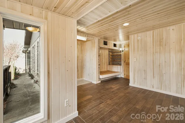 a view of a hallway with wooden shelves