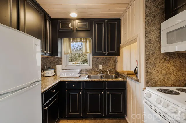 a kitchen with a sink stove and cabinets
