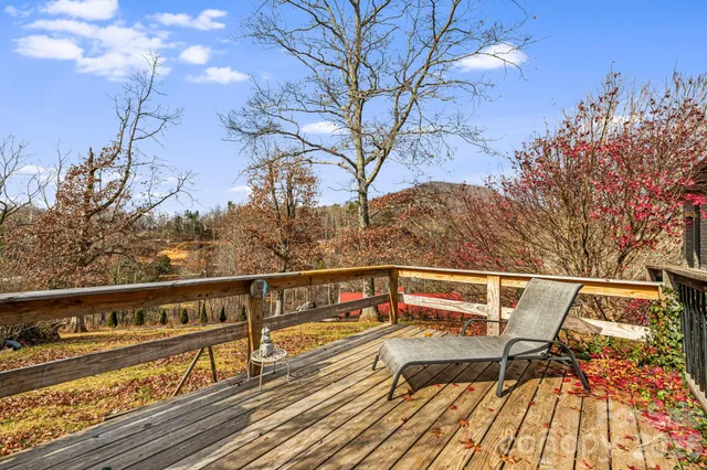a view of deck with seating area and trees