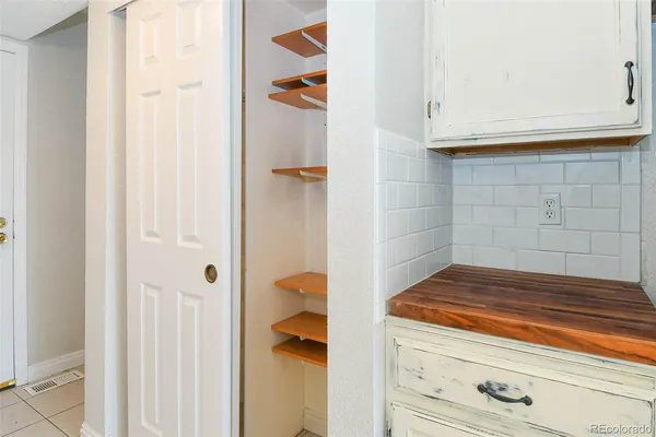 a bathroom with granite countertop white cabinets