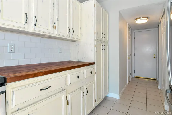 a kitchen with stainless steel appliances granite countertop a refrigerator and a stove
