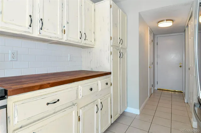 a kitchen with stainless steel appliances granite countertop a refrigerator and a stove