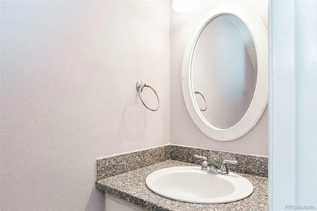 an empty room with closet and a chandelier fan