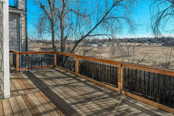 a view of balcony with wooden floor and outdoor seating