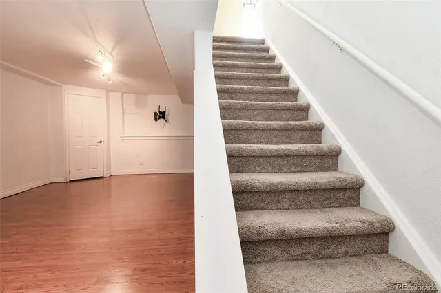 a view of a room with wooden floor and white walls