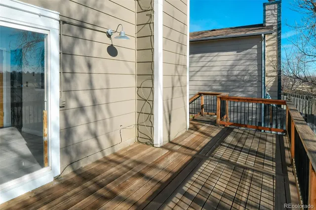 a view of balcony with wooden floor and outdoor seating
