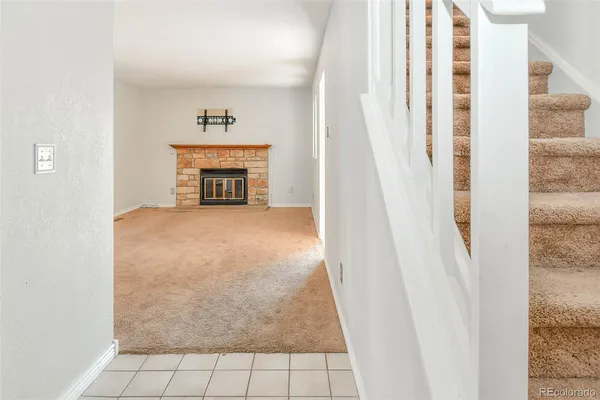 a view of an empty room and fire place