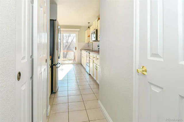 a kitchen with stainless steel appliances white cabinets and a window
