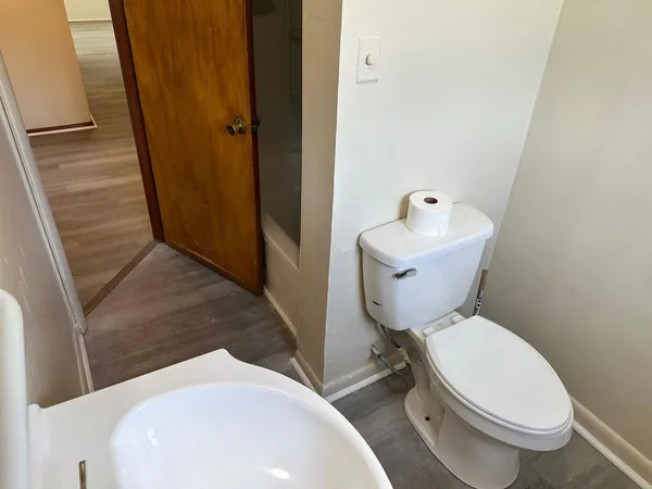 a white toilet sitting next to a bathroom sink
