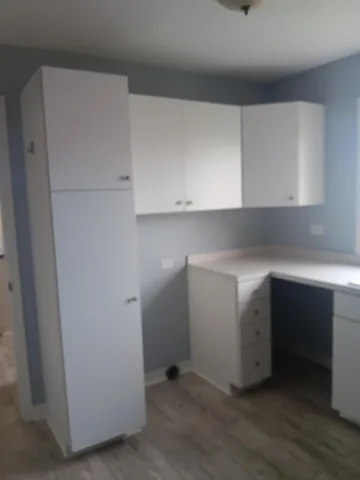 a kitchen with a sink a window and cabinets