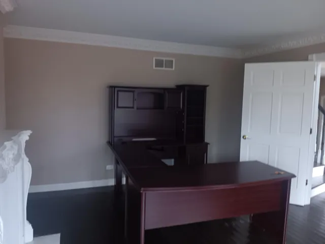 a living room with table chairs and entryway