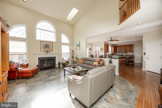 a living room with furniture a fireplace and a large window