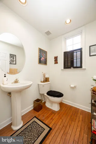 a bathroom with a toilet a sink and mirror