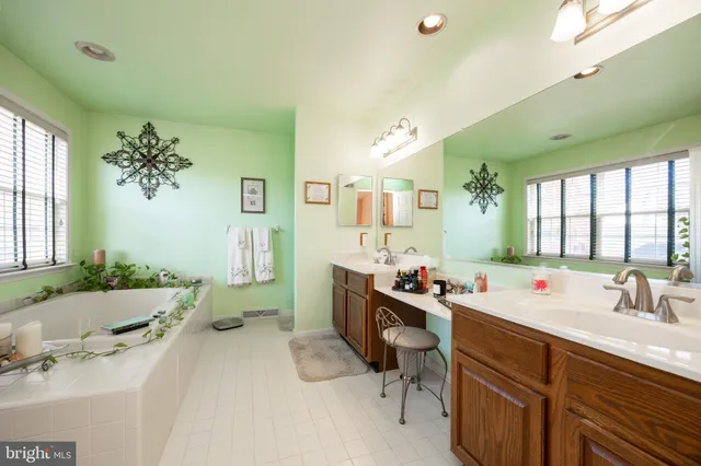 a bathroom with a sink mirror and a bathtub
