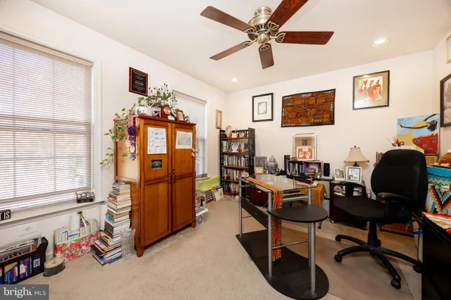 a view of a workspace with furniture and a window