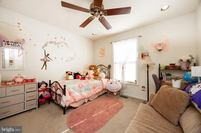 a bedroom with bed and a couch