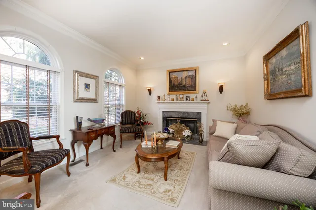 a living room with furniture fireplace and a large window