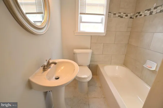 a bathroom with a sink a toilet and a bathtub