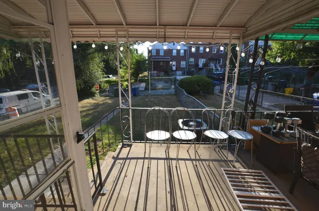 a view of a chairs and tables in patio with a barbeque grill