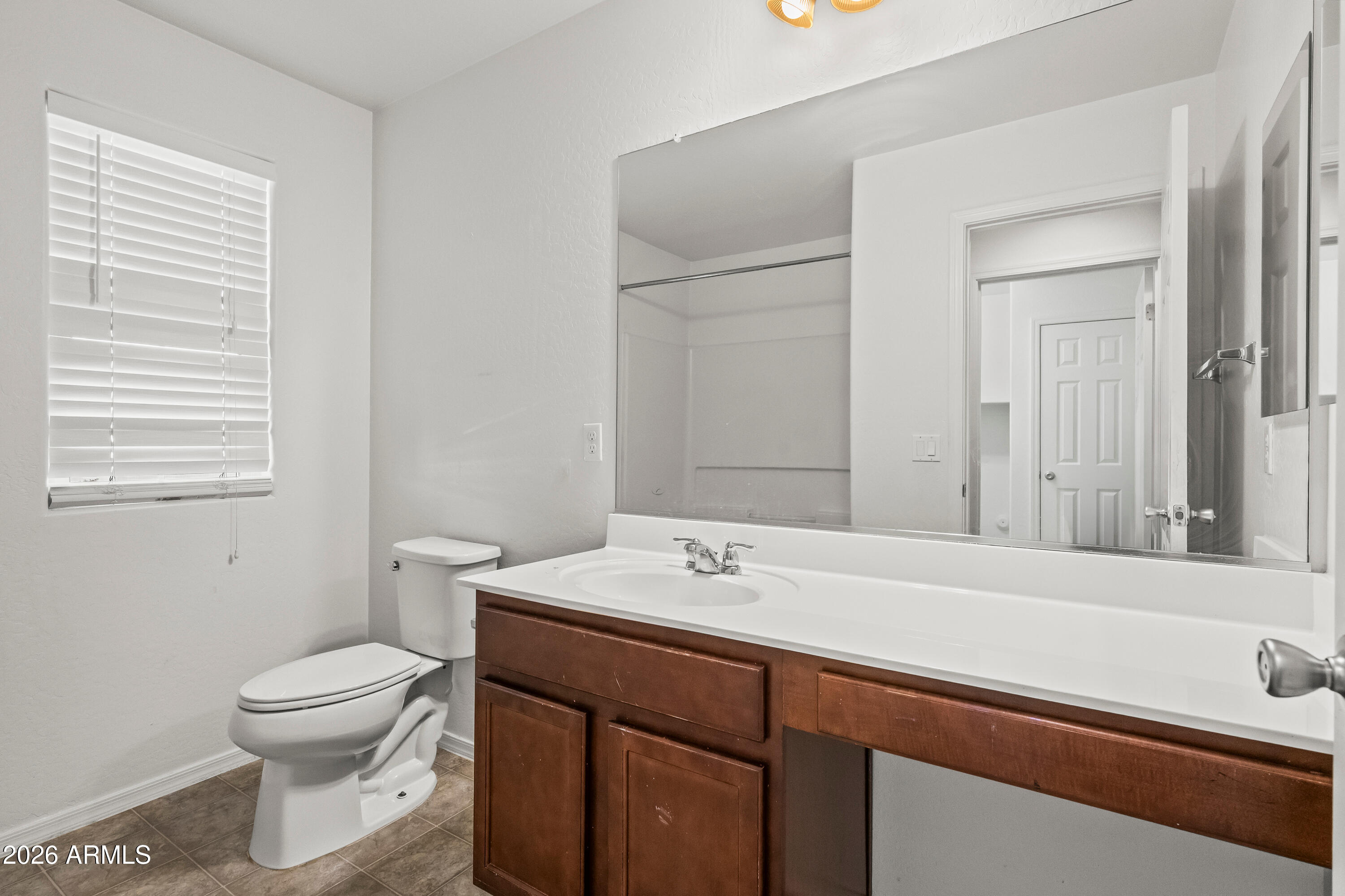 507 North Ranger Trail Gilbert, AZ 85234 - Photo 10 of 19 a bathroom with a toilet sink and mirror