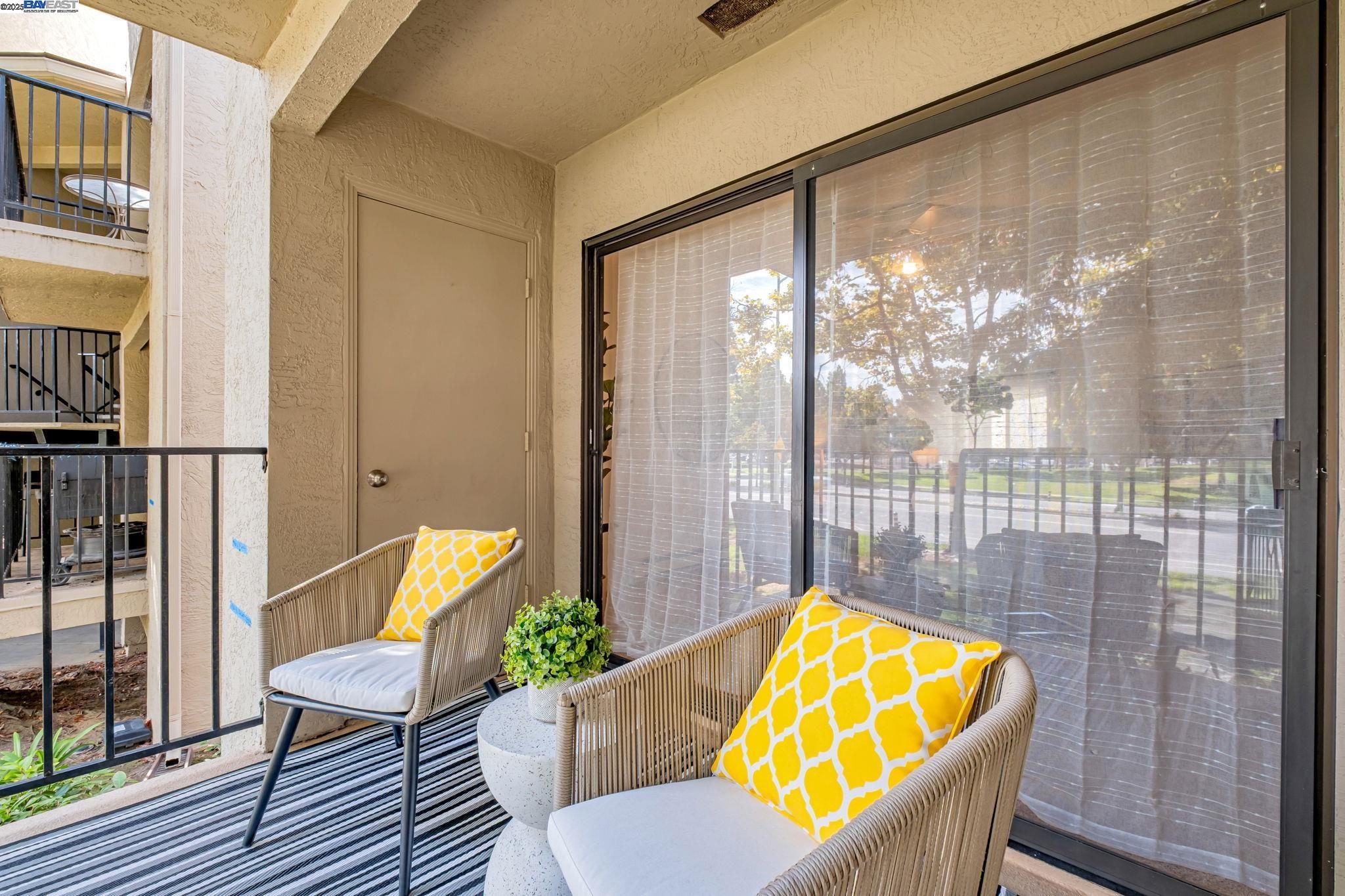 1960 Barrymore Common, Unit K Fremont, CA 94538 - Photo 22 of 31 a view of a bedroom with a large window and wooden floor