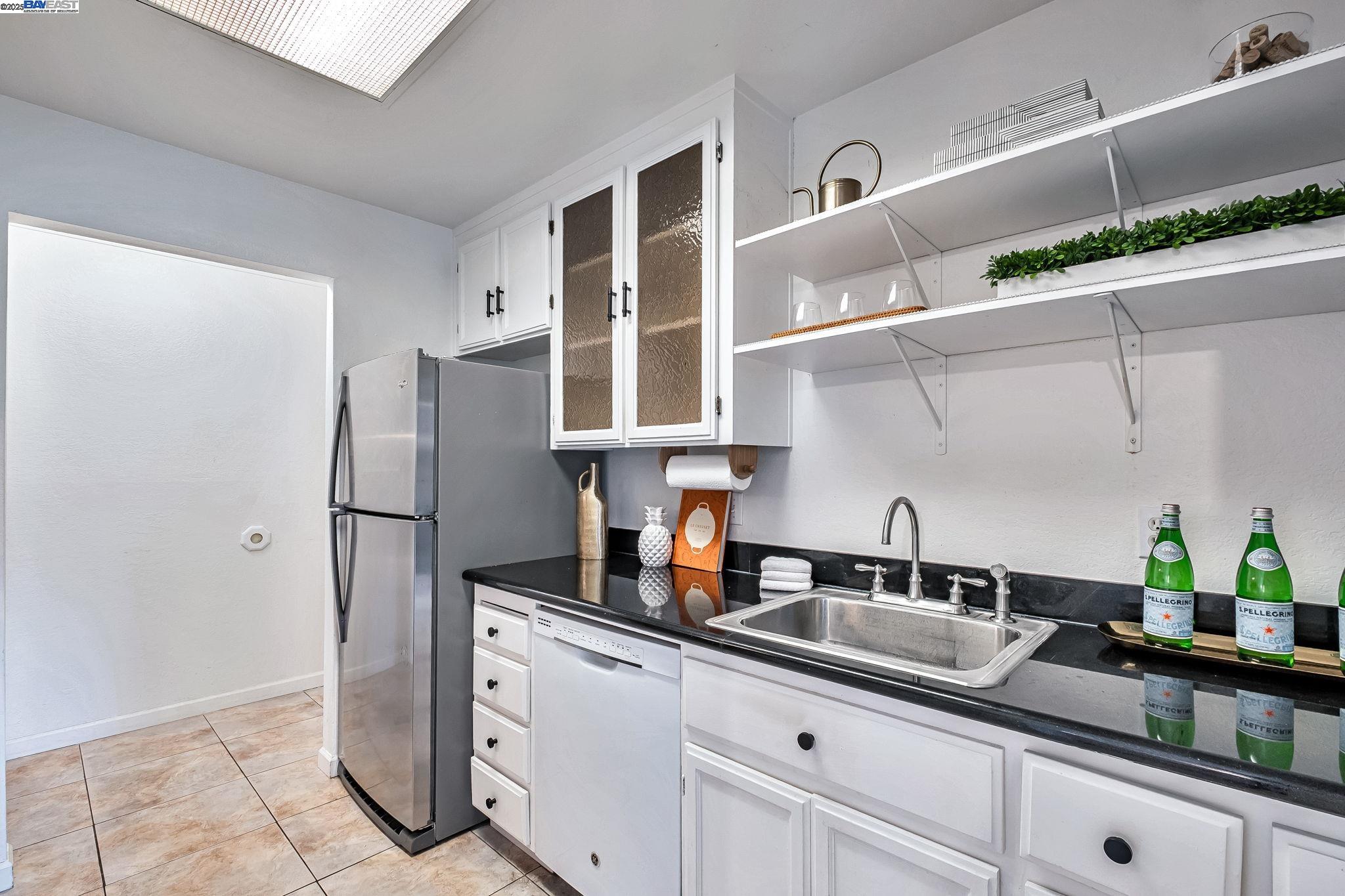 1960 Barrymore Common, Unit K Fremont, CA 94538 - Photo 9 of 31 a kitchen with stainless steel appliances a sink and cabinets