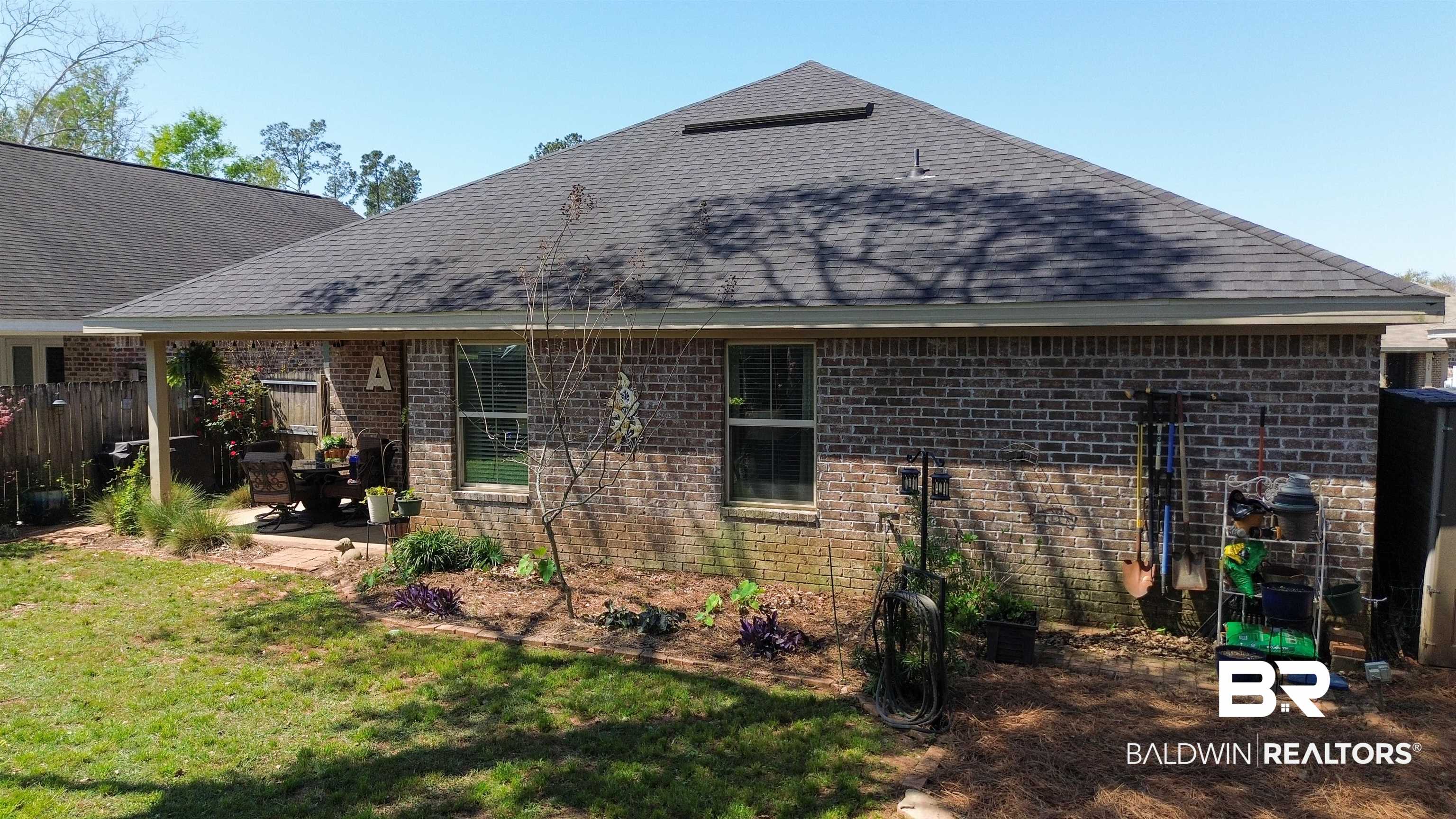 1304 Majesty Loop Foley, AL 36535 - Photo 36 of 44 Rear view of property featuring a shingled roof, brick siding, and a patio area