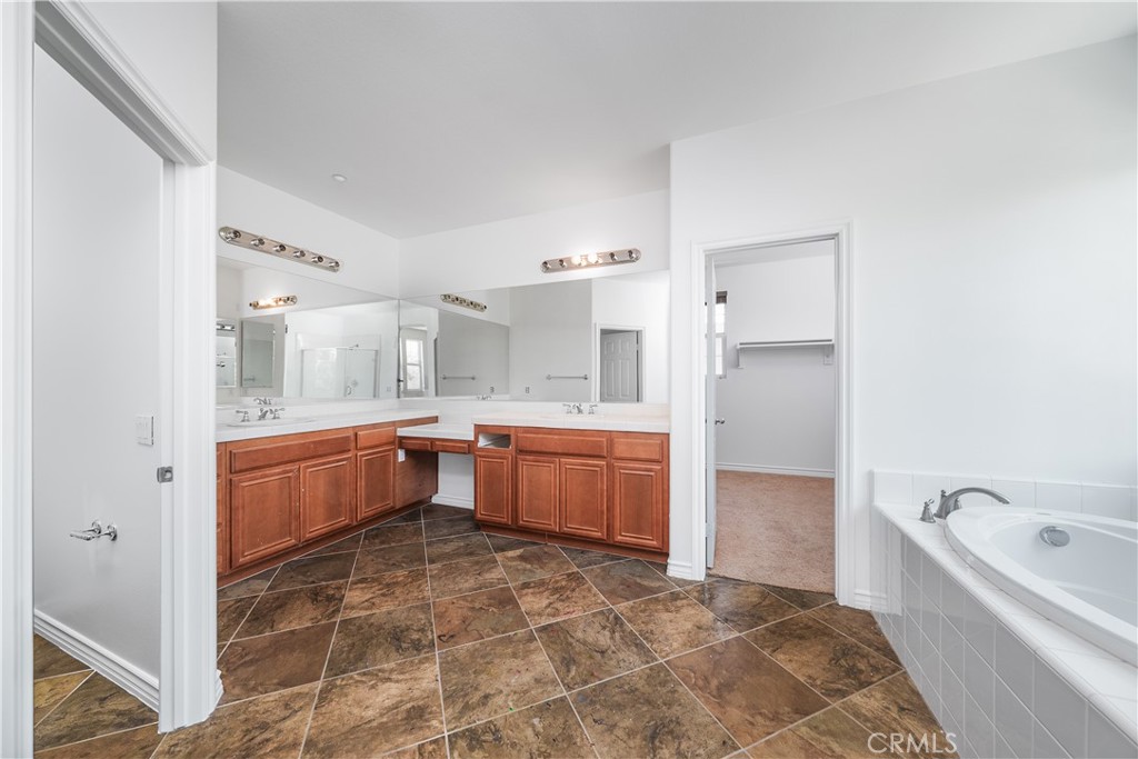 5662 Galasso Avenue Fontana, CA 92336 - Photo 17 of 34 a large white kitchen with a sink and cabinets