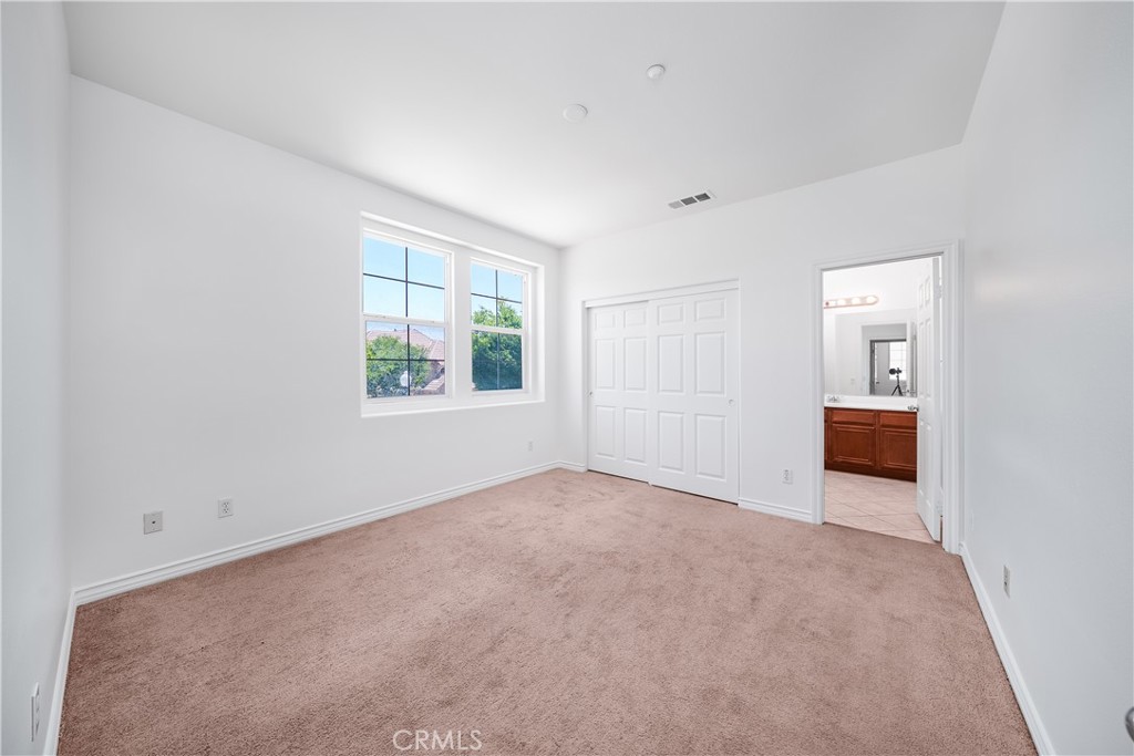 5662 Galasso Avenue Fontana, CA 92336 - Photo 24 of 34 an empty room with a window and a kitchen