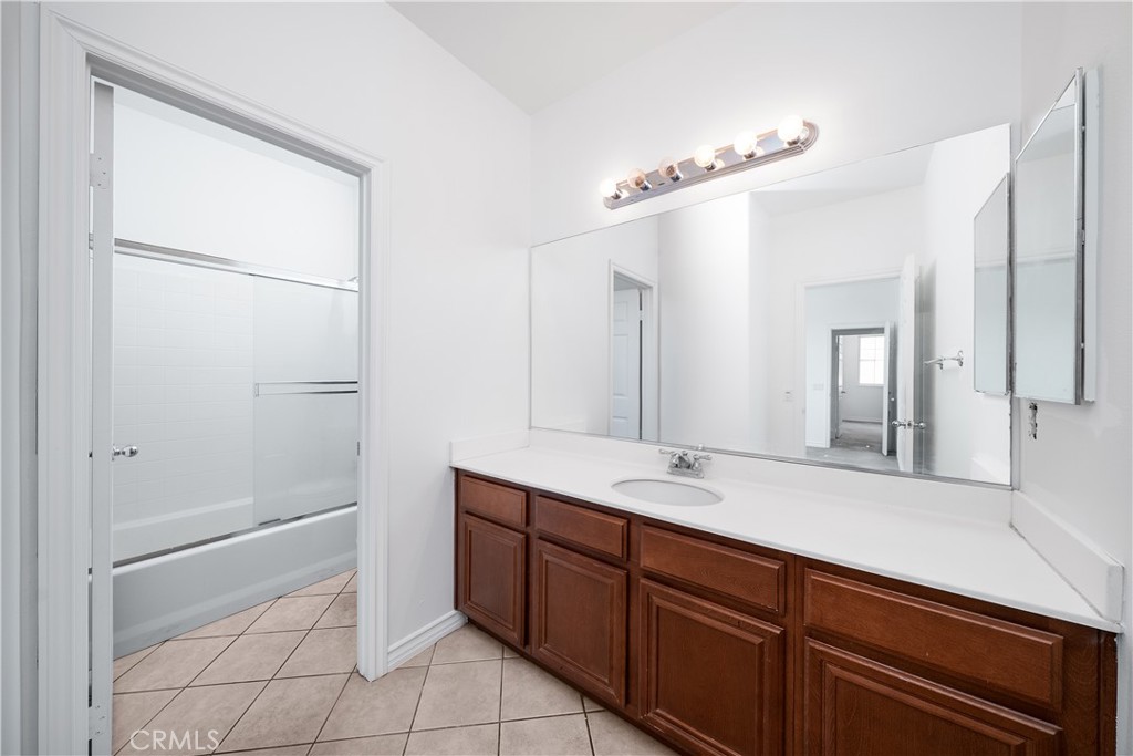 5662 Galasso Avenue Fontana, CA 92336 - Photo 25 of 34 a spacious bathroom with a double vanity sink a mirror and a shower