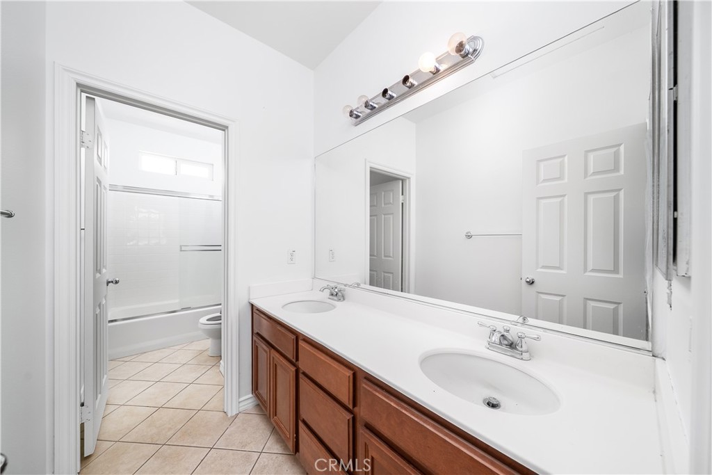 5662 Galasso Avenue Fontana, CA 92336 - Photo 27 of 34 a spacious bathroom with a double vanity sink mirror and double