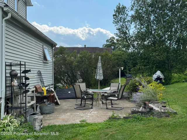 a view of a house with backyard and sitting area