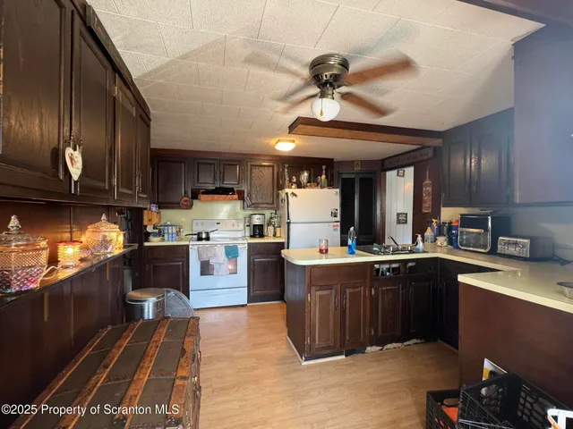 a kitchen with a sink stainless steel appliances and cabinets