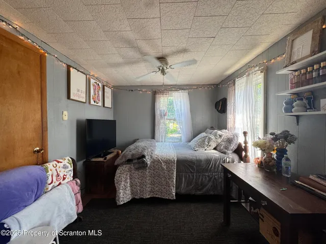 a bedroom with furniture and a window