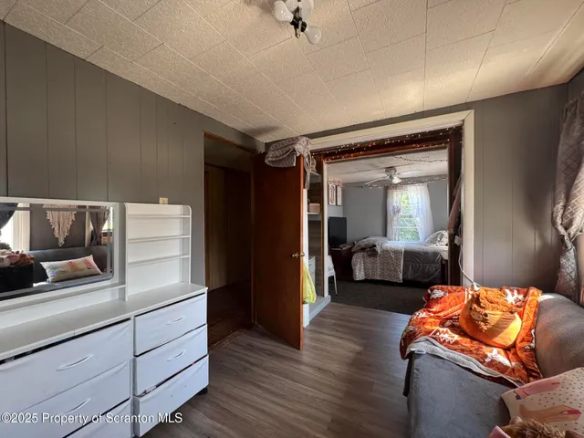 a bedroom with furniture and a mirror