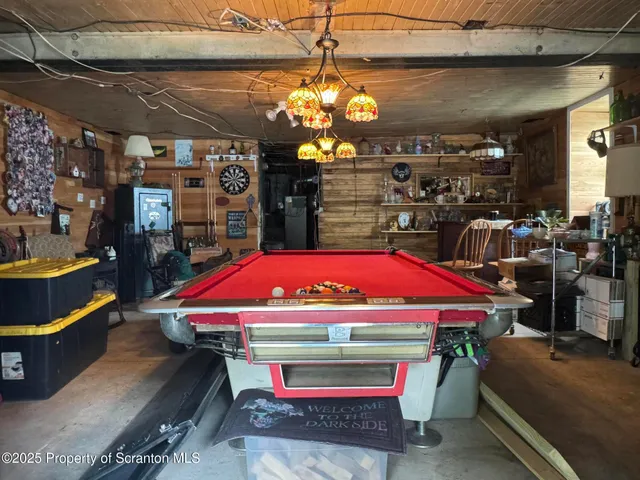 a room with pool table and windows