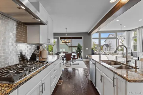 a kitchen with counter top space a sink and stainless steel appliances