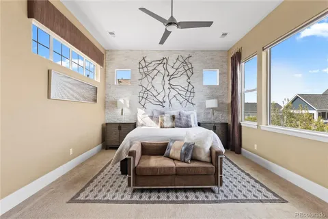 a bedroom with a bed couch and window