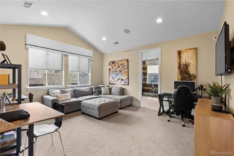 a living room with furniture and large windows