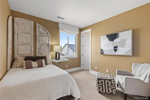 a bedroom with a bed and a couch
