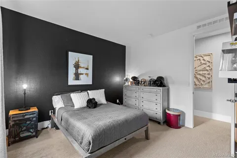 a bedroom with a bed and a lamp