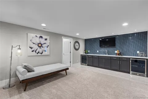 a spacious bedroom with a bed a couch and cabinet
