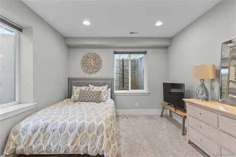 a bedroom with a large bed and a tv on dresser