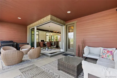 a living room with furniture and large windows