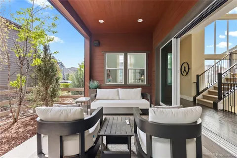 a view of a patio with couches and potted plants