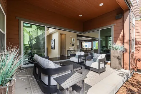 a living room with patio furniture and a large window